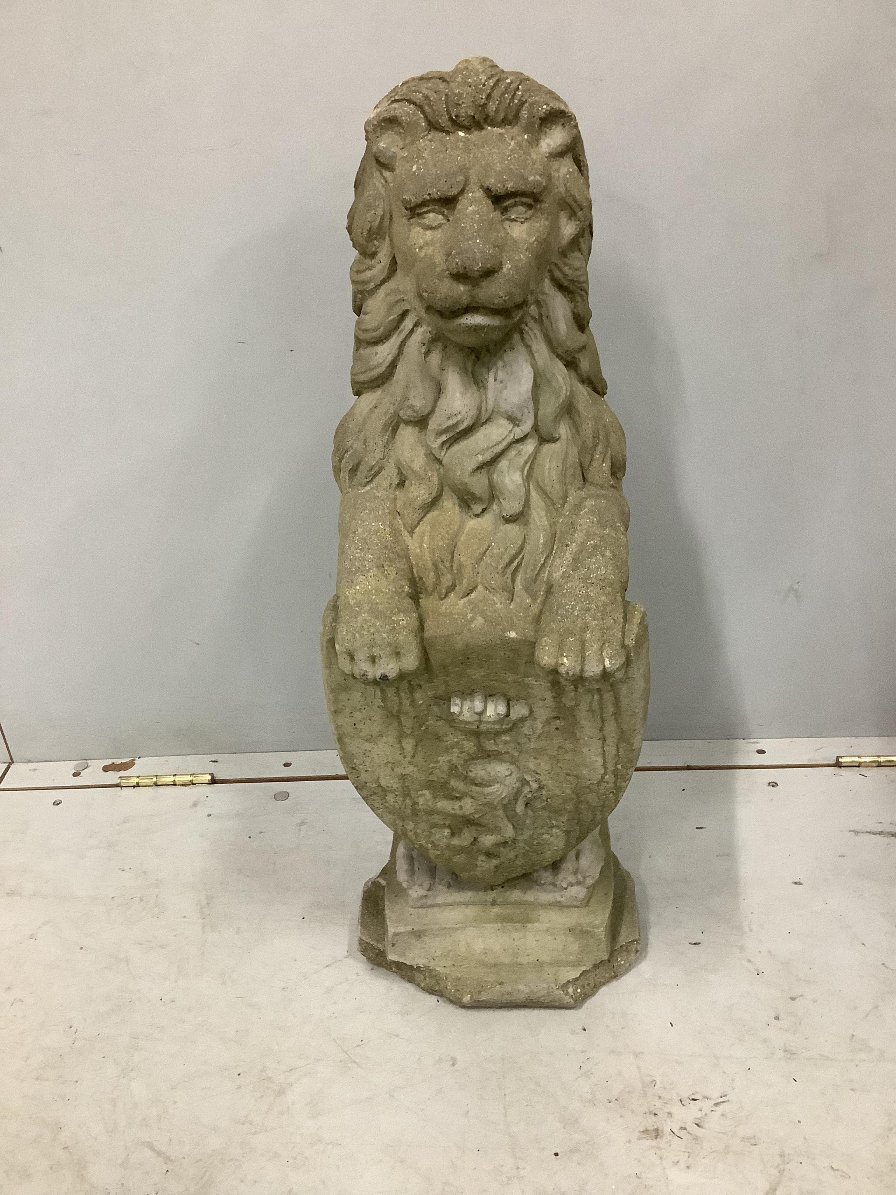 A reconstituted stone heraldic lion garden ornament, height 72cm. Condition - poor to fair, plinth base chipped